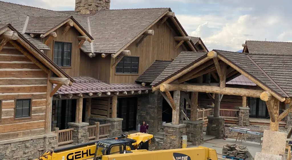 Front view of large home with carport and decorative timber